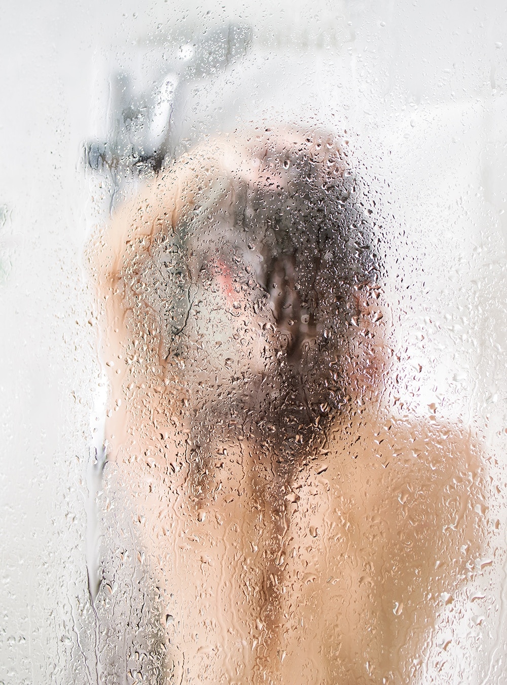 Woman in the shower washing her hair