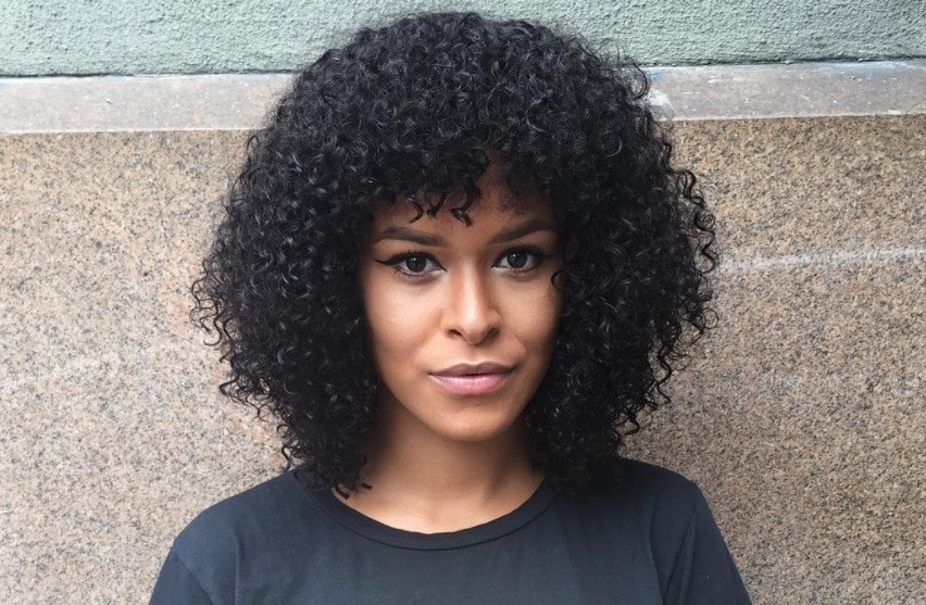 Layered bob: Woman with naturally curly hair with a bob cut and fringe