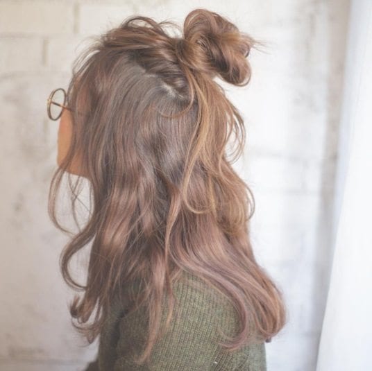 Image of Wavy hair with a half-up, half-down bun hairstyle for long hair