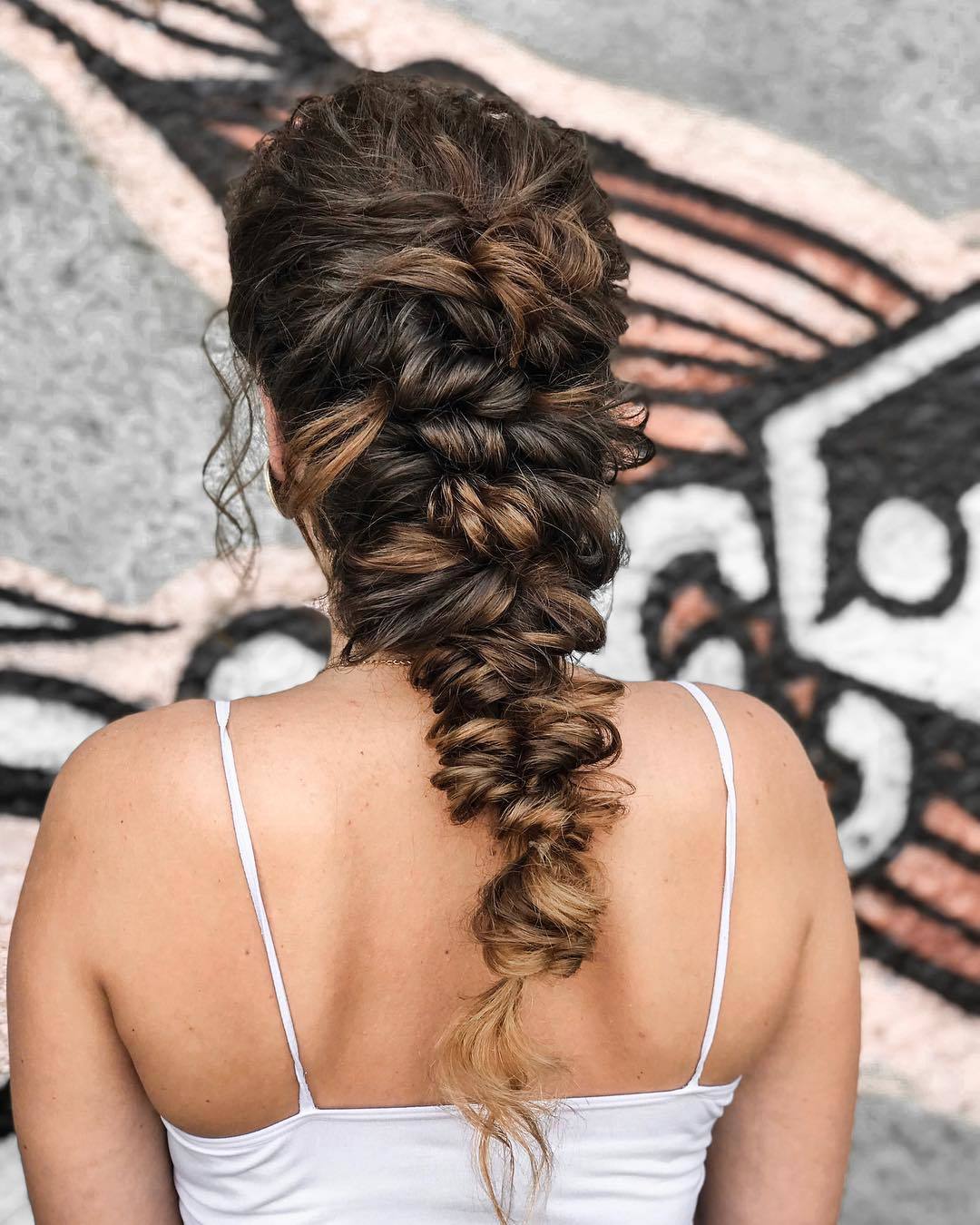 Brunette woman with a long Greek braid hairstyle
