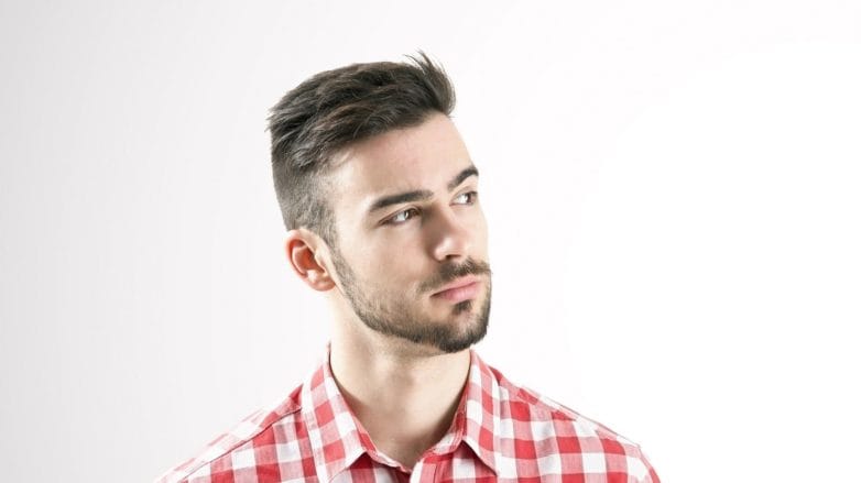 Dandruff solutions: Caucasian man with short dark hair and mustache wearing a red and white checkered top